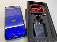 Phone powered on showing “Hi there” Android setup screen with punch-hole camera top-left; phone in black case