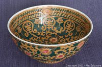Full exterior view of vintage ceramic bowl showing ornate hand-painted Oriental golden and floral patterns on dark green background