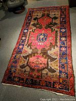Full view of rug showing entire geometric medallion pattern