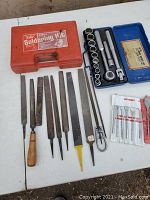 Overview of soldering kit case, assorted metal files of various shapes and sizes, and wood drill bits in packaging.
