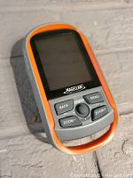 Front view of Magellan eXplorist 310 GPS showing orange and gray casing, screen, and control buttons