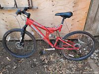 Side view of red Mongoose bike showing frame, seat, handlebars and tires