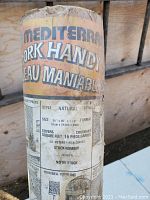 Close-up of the original wrapping label on the cork roll detailing size, style, and coverage in square feet and meters.