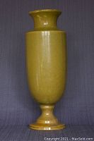 Front view of tall mustard-yellow glazed ceramic umbrella holder showing full height and base detail.