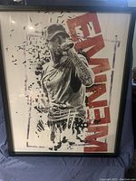 Framed large portrait-style poster of Eminem holding a microphone with the name 'Eminem' in bold red text.