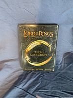 Front cover of The Lord of the Rings 3-Film Collection DVD box set showing the title and gold ring graphic.