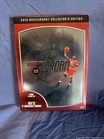 Front cover of Michael Jordan 20th Anniversary Collector's Edition DVD set showcasing an image of Jordan in a dunk pose with text highlighting MJ's 5 greatest games.