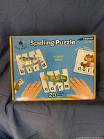 Front of box showing 'Spelling Puzzle' by Star Right with example puzzles 'bird', 'corn', 'dog'.