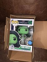 She-Hulk Pop! figure inside box in a shipping box, showing clear front window and figure inside.
