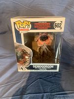Front view of the original box showing the Demogorgon figure inside with clear window and branding.