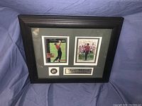 Full view of the framed Tiger Woods memorabilia showing two golf cards/photos, a signature plaque, and a logo with a 2003 PGA Player of the Year label.