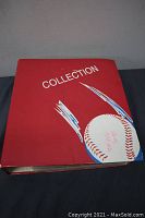 Red binder with baseball graphic and 'Collection' text on front cover