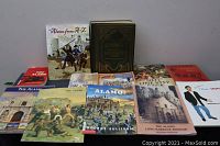 Several books laid out on a flat surface showing various titles mostly related to the Alamo and local history.