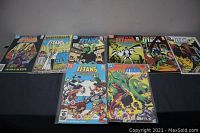 Nine vintage DC Titans comic books arranged in two rows showing front covers and various storylines.