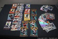 Photo showing multiple McDonald's promotional hockey card sets displayed on a dark surface. Cards include various player images, team logos, and special designs with foil and shimmer effects.