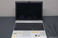 Front view of Sony Vaio laptop with screen and keyboard visible.