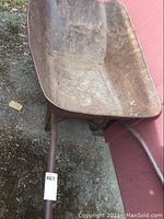 Photo of the wheelbarrow basin showing rust and wear.