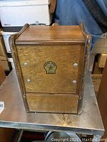 Front view of wooden enclosure with Magic Mill logo