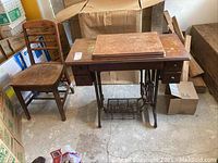 Full lot view showing sewing machine cabinet with separate chair