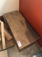 Closed view of weathered wooden tool chest from above