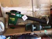 Photo showing green Weed Eater blower and green hedge trimmer placed on a shelf.