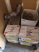 Photo displaying stacked cardboard cases containing mason jars, labeled 4-1 GAL indicating 4-quart jars.