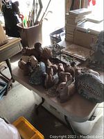 View of squirrels, bunnies, deer, girl on gate, welcome stones on table indoors