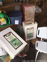 Boxes of two Victory Garden handcrafted hanging lanterns and one Santa Fe Lantern for outdoor use.