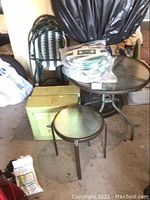 Overall view of bistro set items including round table, chairs, boxed end tables and cushions