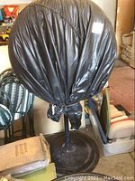 Black nylon protective cover fitted over fan head, front view