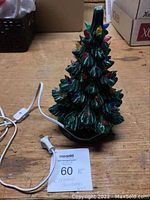 Front view of the green ceramic Christmas tree showing detailed branches and multicoloured bulbs.
