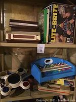 Shelf with vintage Fisher Price Phonograph and Classic Lite-Brite in original box along with blue xylophone toy