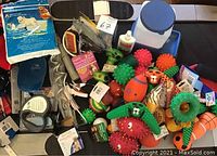 Overview of dog toys including textured rubber toys, rope toys, and small plush toys along with grooming items like shampoo and pedicure clippers.