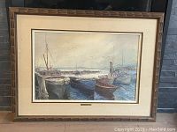 Full view of framed oil painting showing harbor scene with boats and carved wooden frame