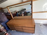Mid century wooden Kroehler dresser with attached mirror, angled view showing drawers and surface condition.