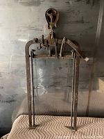 Full view of the early Beatty hay fork showing its frame, pulley at top, and lever system for lifting hay bales.