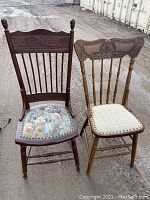 Two wooden pressed back chairs shown outdoors, highlighting their carved backs and upholstered seats.