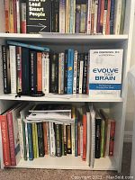 Photo of the white bookshelf filled with books to demonstrate size and shelf distribution. Books are visible but not included with the sale.