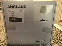 Boxed Ängland table lamp indicating 57 cm height and pleated lampshade