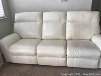 Frontal view of the three-seater white leather couch