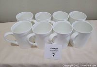 Eight white Mikasa Burks Falls coffee mugs arranged in two rows, showing side and handle details.