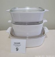 Set of 3 white Pyrex Corning Ware casserole dishes stacked showing their size difference.