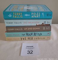 Five Terry Fallis paperback books stacked one on another showing spines.