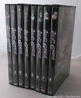Photo showing spines of the 8 Blue Gender DVD cases, numbered 1-8 with character images and title.