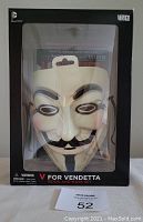 Front view of sealed box containing V For Vendetta mask and book with DC Black Label branding
