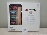 Front view of the Pottery Barn Kids Train Set box showing four wooden train cars in plastic window and branding on the box.