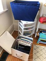 Photo of four drawer white plastic storage bin filled with pens, paint, tape, rulers, and craft supplies.