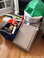 The full collection of cat entertainment items showing the beige cat climber with carpet scratching panels, the plush cat bed with green small tent on top, and the blue and yellow collapsible tunnel.