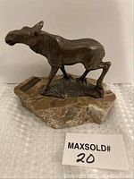 Front view of bronze moose sculpture on marble base