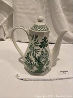 Front view of the J&G Meakin Royal Staffordshire Willow Ironstone coffee urn, showing spout, handle, and scenic Willow pattern design in green on white body.